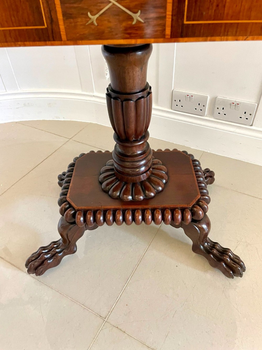 A Regency fold-over rosewood card table with brass inlay, a central pedestal, and carved lion paw feet. View IX