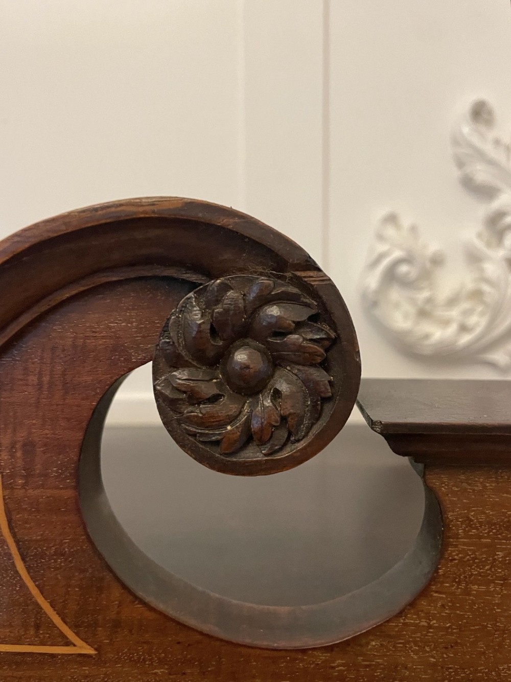 An antique mahogany display cabinet featuring a swan neck pediment, marquetry inlays, glazed double doors, interior glass shelves, and square tapered legs. View IV