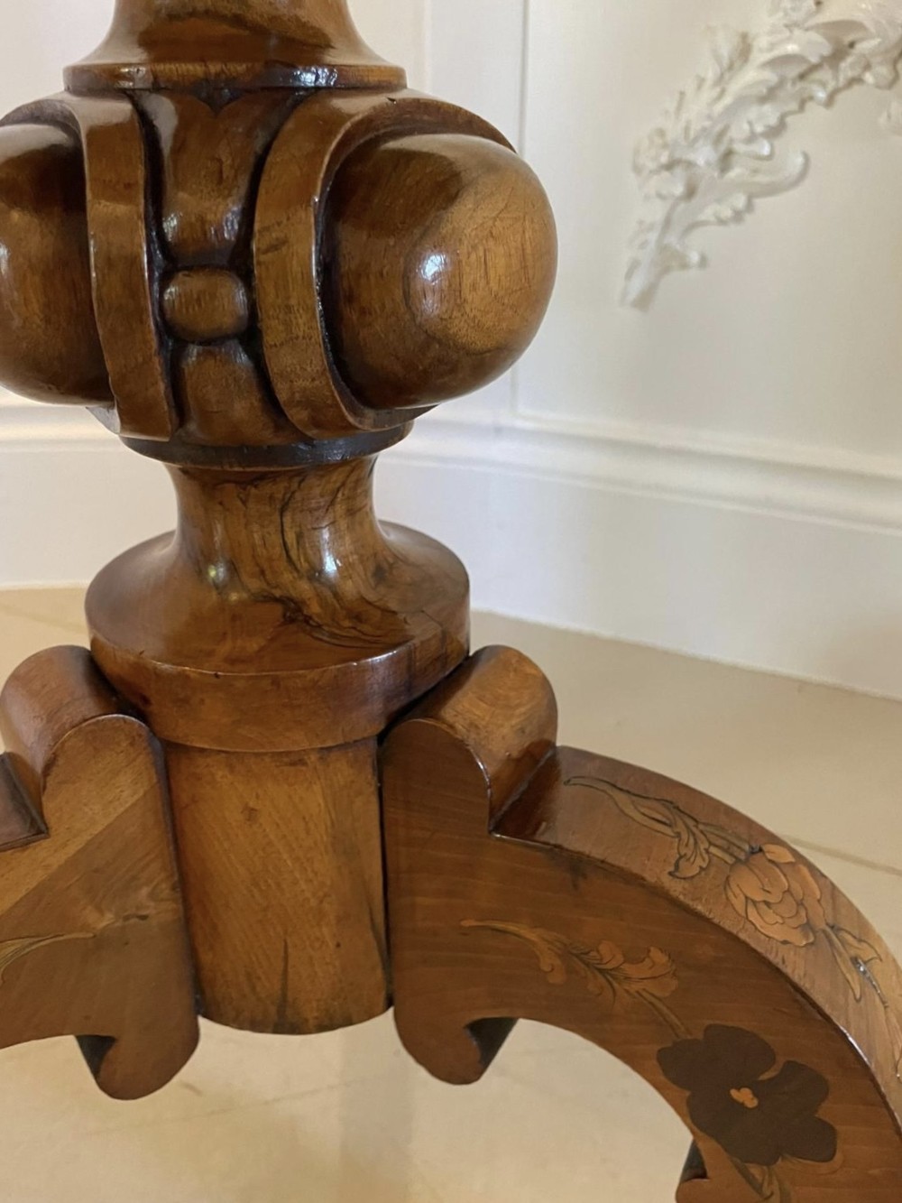 A Victorian walnut occasional table featuring a scalloped rim, intricate marquetry floral inlay on the tabletop, a turned central pedestal, and three carved cabriole legs. View XI