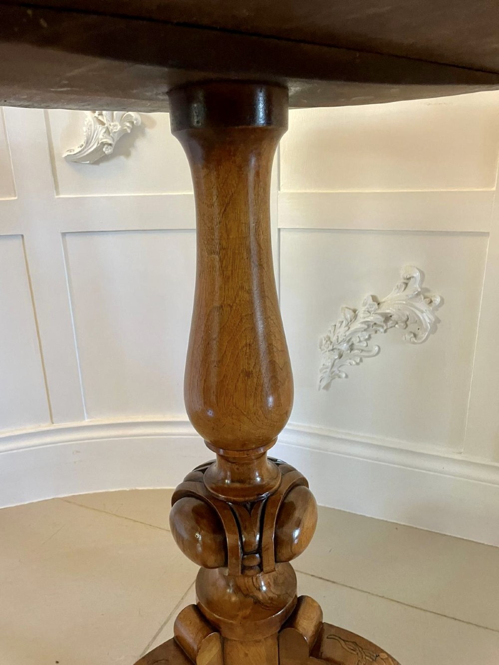 A Victorian walnut occasional table featuring a scalloped rim, intricate marquetry floral inlay on the tabletop, a turned central pedestal, and three carved cabriole legs. View XII