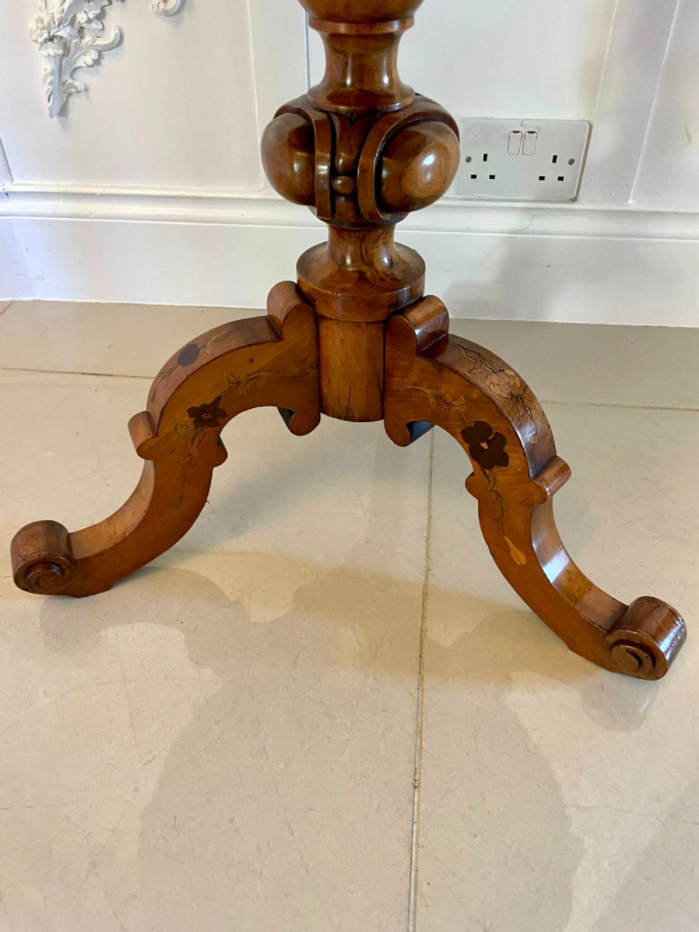 A Victorian walnut occasional table featuring a scalloped rim, intricate marquetry floral inlay on the tabletop, a turned central pedestal, and three carved cabriole legs. View XIII