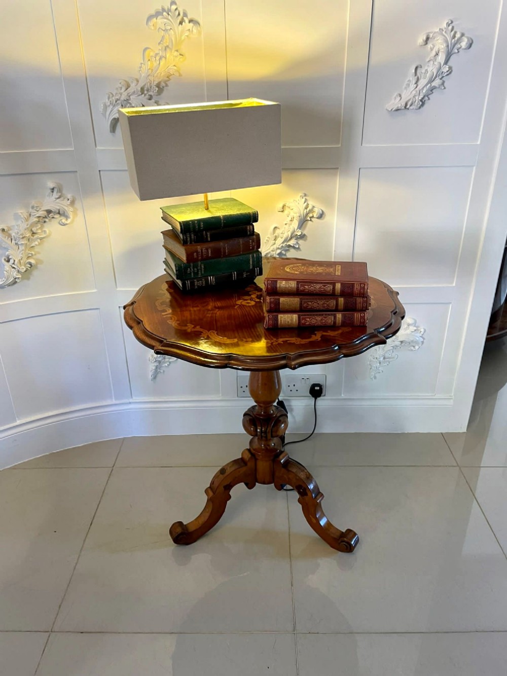 A Victorian walnut occasional table featuring a scalloped rim, intricate marquetry floral inlay on the tabletop, a turned central pedestal, and three carved cabriole legs. View XV
