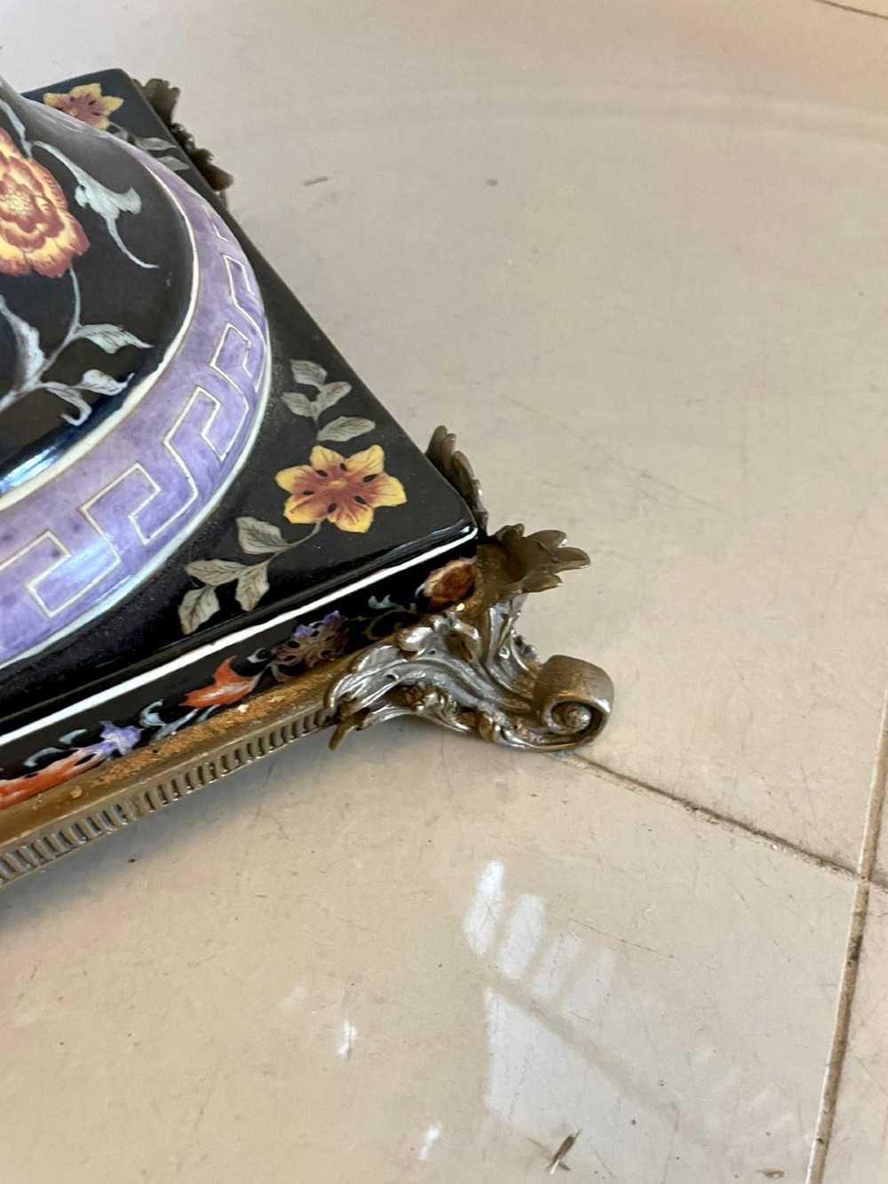 A pair of black French porcelain jardiniere urns featuring polychrome floral enamel, central painted animal reserves, and gadrooned brass mounts on square plinths. View III
