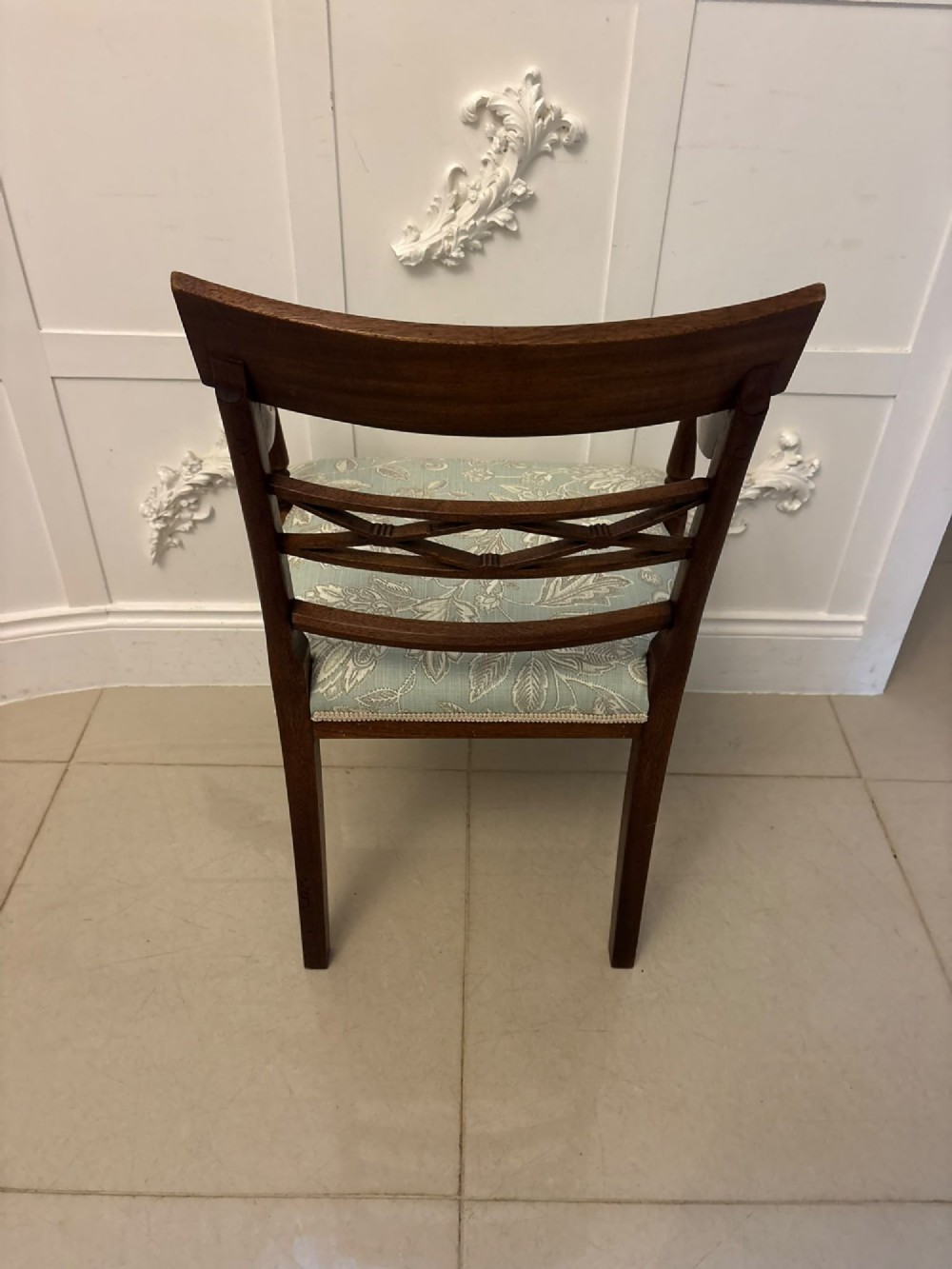 A set of ten Edwardian mahogany dining chairs, including two carver armchairs, featuring lattice backrests and pale blue patterned fabric upholstery. View IV