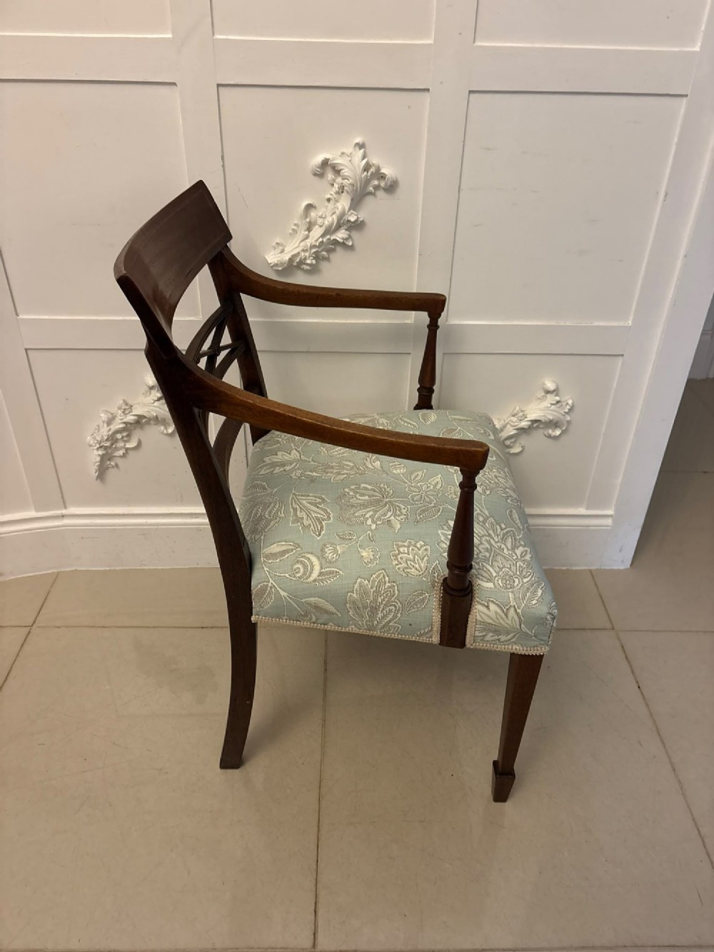 A set of ten Edwardian mahogany dining chairs, including two carver armchairs, featuring lattice backrests and pale blue patterned fabric upholstery. View V