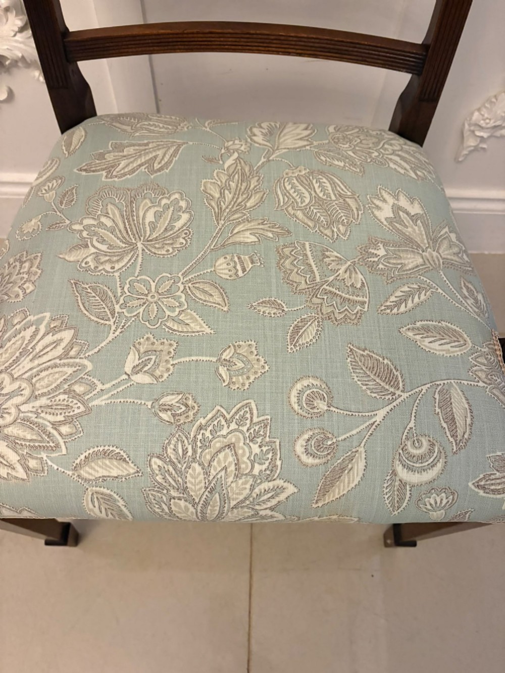 A set of ten Edwardian mahogany dining chairs, including two carver armchairs, featuring lattice backrests and pale blue patterned fabric upholstery. View VII