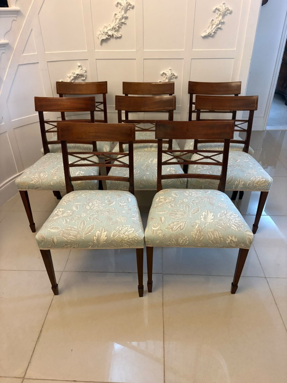 A set of ten Edwardian mahogany dining chairs, including two carver armchairs, featuring lattice backrests and pale blue patterned fabric upholstery. View XIII