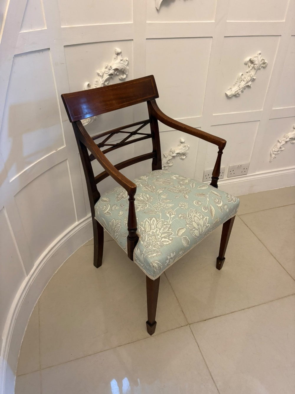 A set of ten Edwardian mahogany dining chairs, including two carver armchairs, featuring lattice backrests and pale blue patterned fabric upholstery. View XIV