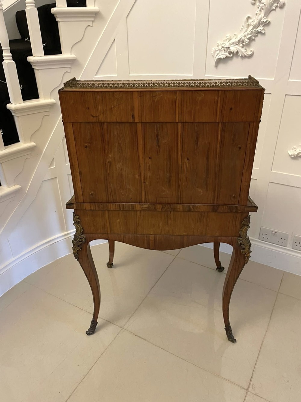A French Rococo revival slant-front kingwood bureau featuring delicate ormolu mounts, a central hand-painted porcelain plaque, and elegant cabriole legs. View II