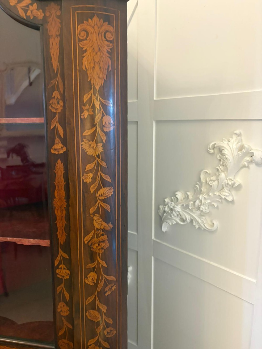 A 19th-century two-tier Dutch marquetry corner cabinet featuring intricate floral inlays, an arched glazed top door, and a solid lower cupboard door. View IX