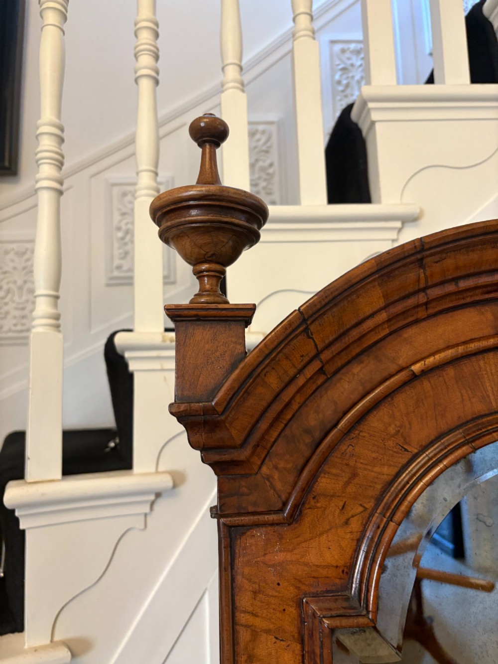 An antique Queen Anne burr walnut bureau bookcase featuring a double-domed cresting with urn finials, double mirrored doors, a sloping fall-front desk section, and a chest of drawers on bun feet. View XIII