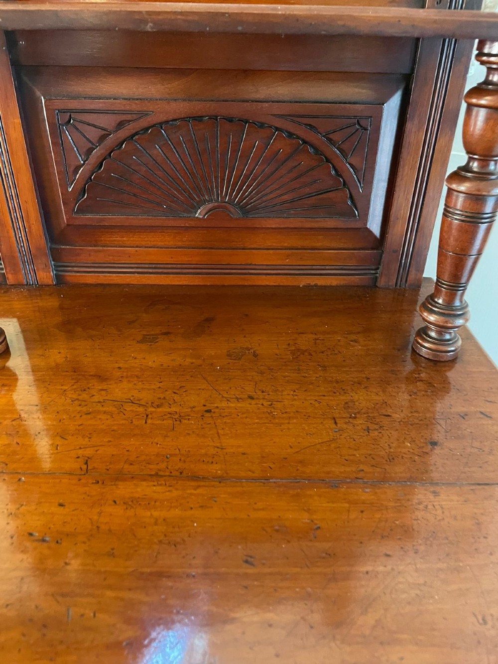 A carved walnut Victorian mirror-back sideboard featuring turned columns, carved fan panels, multiple mirrors, and brass drawer handles. View III