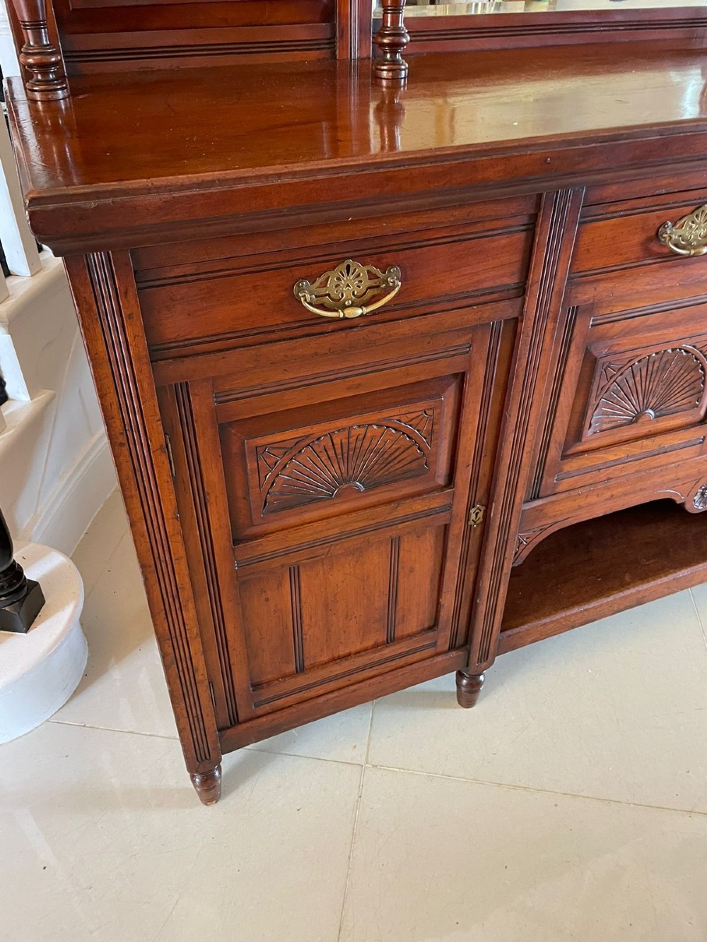 A carved walnut Victorian mirror-back sideboard featuring turned columns, carved fan panels, multiple mirrors, and brass drawer handles. View IV