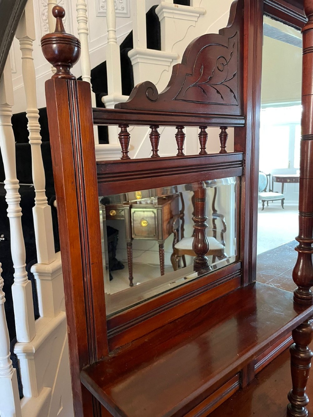 A carved walnut Victorian mirror-back sideboard featuring turned columns, carved fan panels, multiple mirrors, and brass drawer handles. View VI