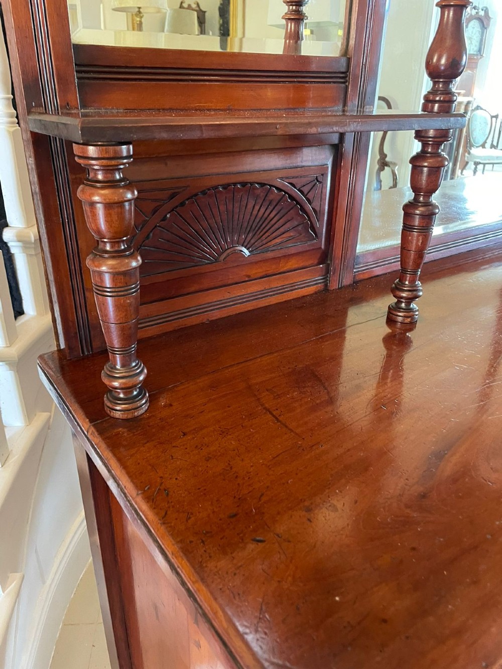 A carved walnut Victorian mirror-back sideboard featuring turned columns, carved fan panels, multiple mirrors, and brass drawer handles. View VII