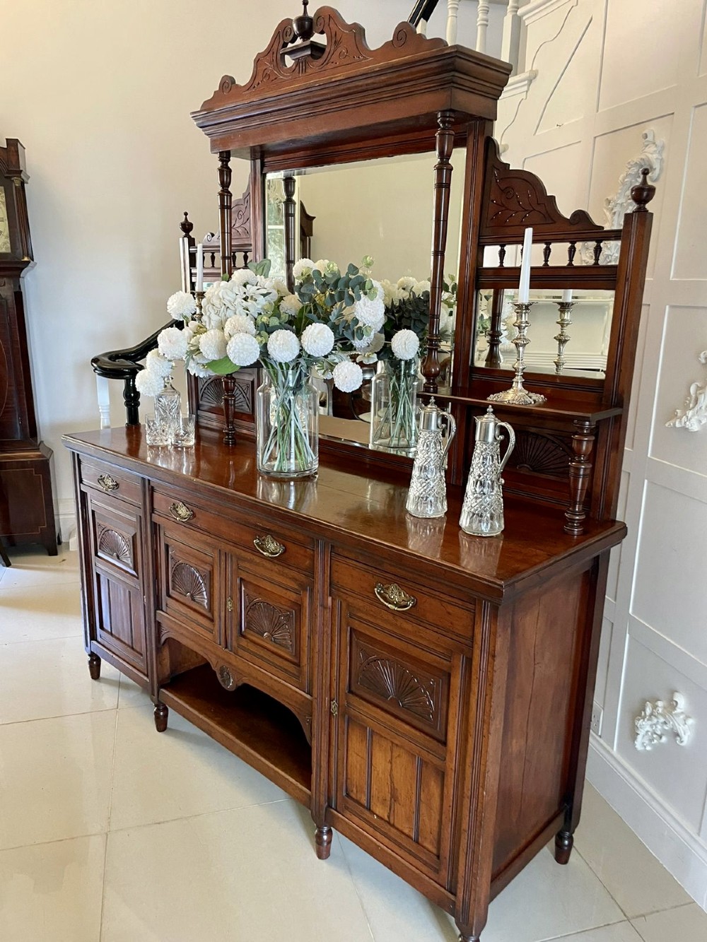A carved walnut Victorian mirror-back sideboard featuring turned columns, carved fan panels, multiple mirrors, and brass drawer handles. View VIII