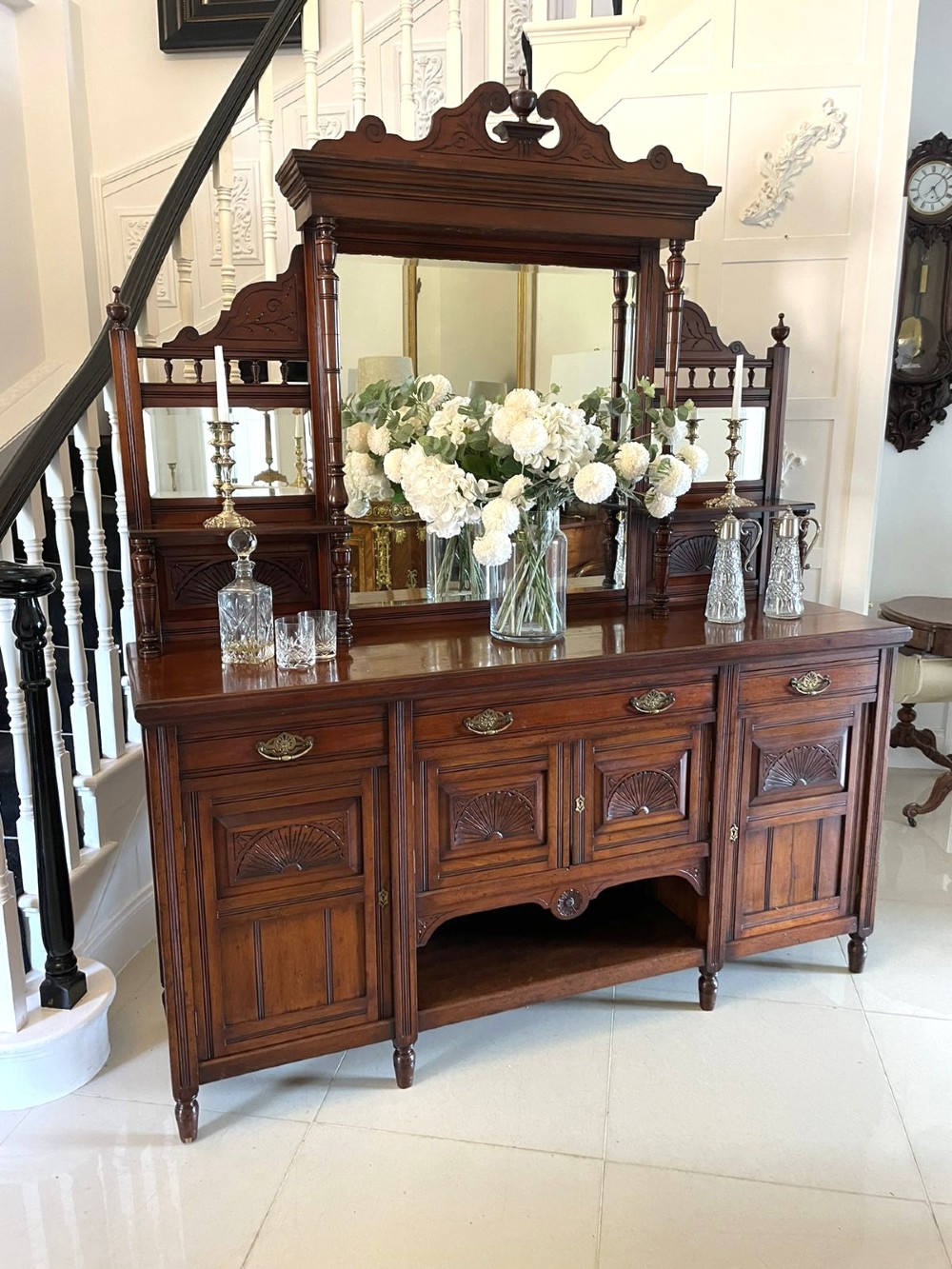 A carved walnut Victorian mirror-back sideboard featuring turned columns, carved fan panels, multiple mirrors, and brass drawer handles. View IX
