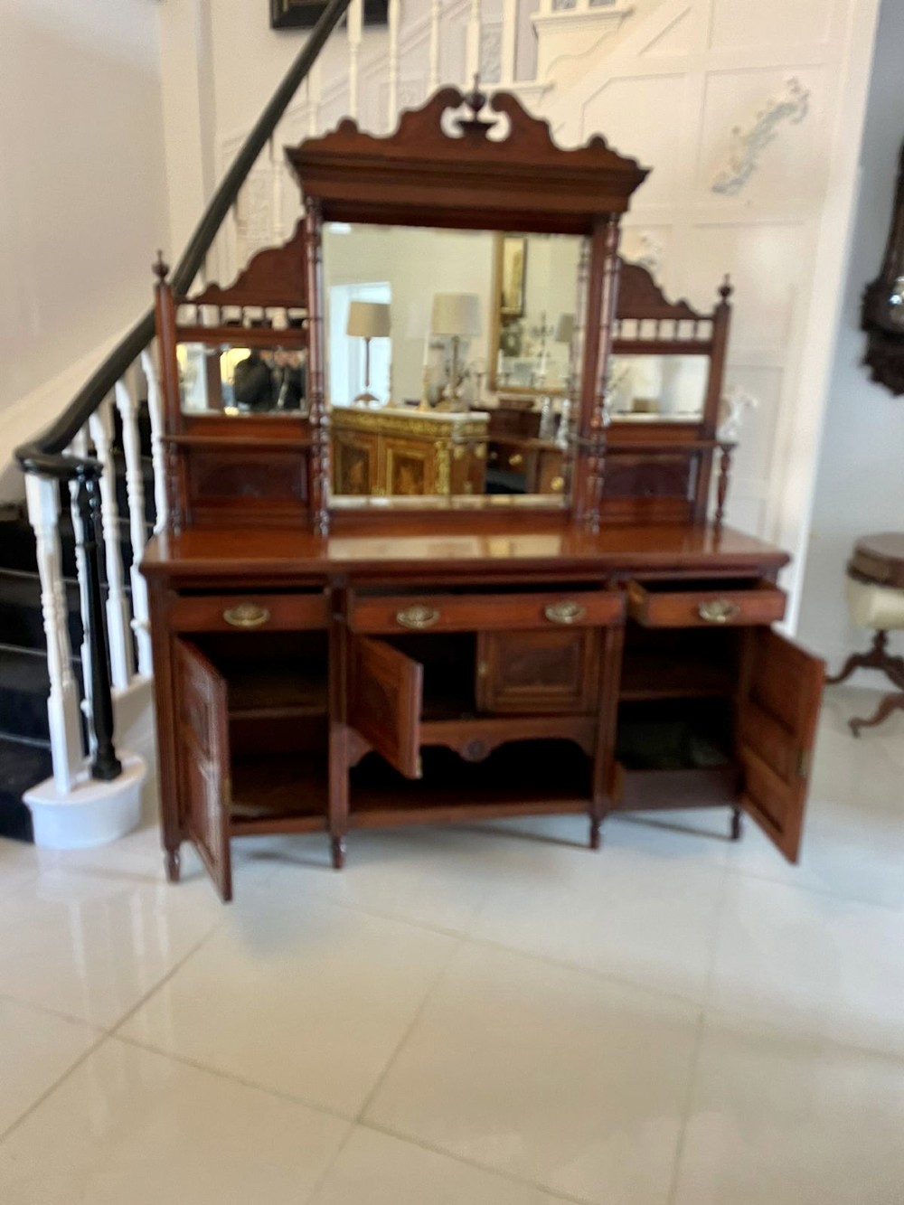 A carved walnut Victorian mirror-back sideboard featuring turned columns, carved fan panels, multiple mirrors, and brass drawer handles. View X