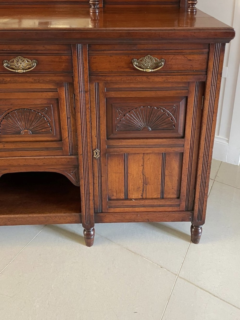 A carved walnut Victorian mirror-back sideboard featuring turned columns, carved fan panels, multiple mirrors, and brass drawer handles. View XI