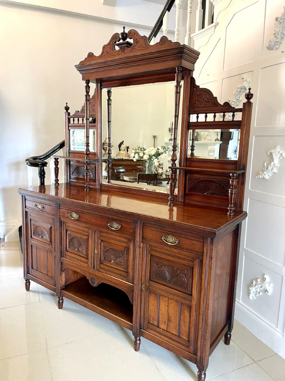 A carved walnut Victorian mirror-back sideboard featuring turned columns, carved fan panels, multiple mirrors, and brass drawer handles. View XIII
