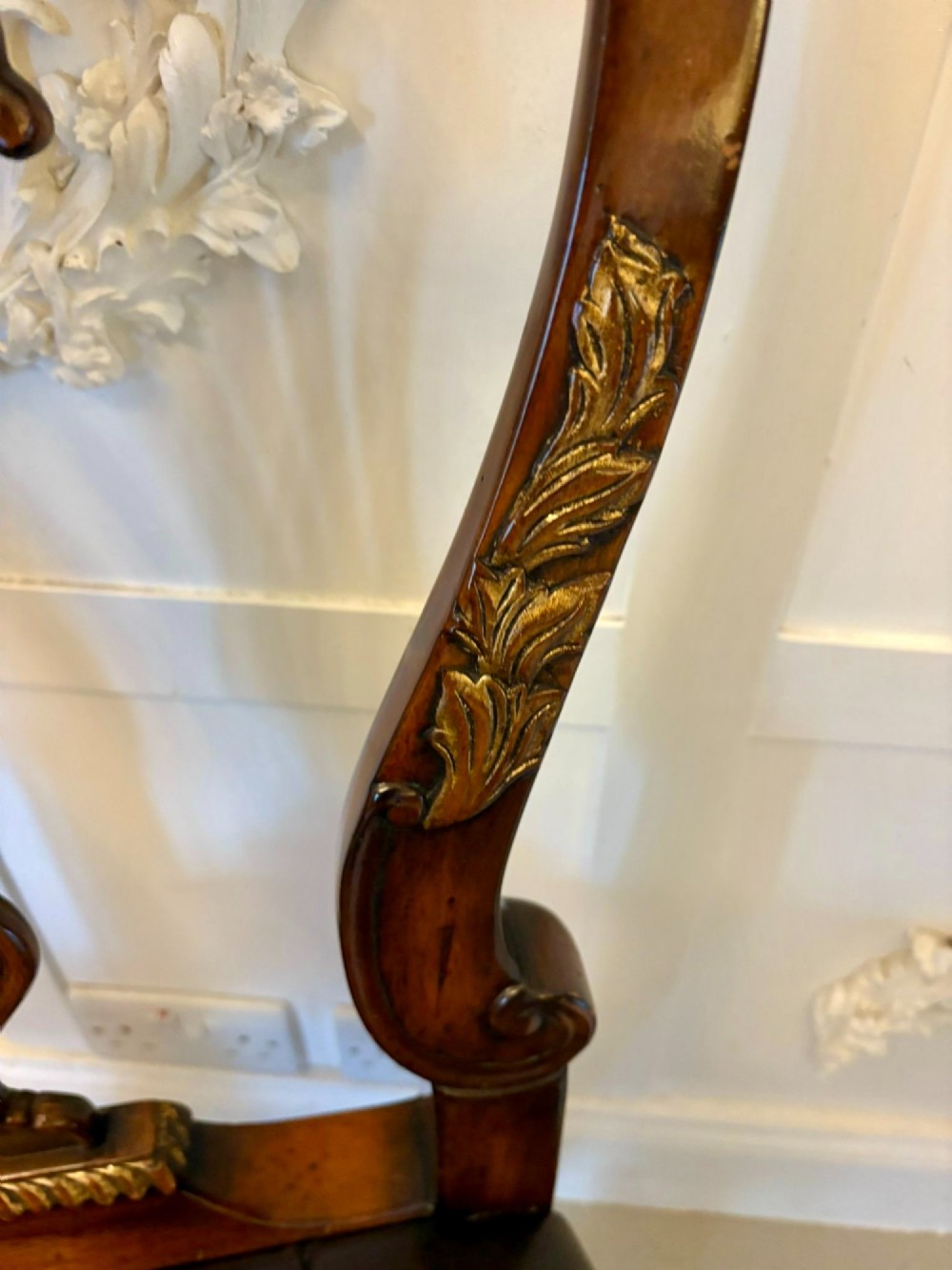 Set of eight Edwardian carved walnut dining chairs featuring pierced backrests, gilded highlights, cabriole legs, and dark brown button-tufted leather seats. View III