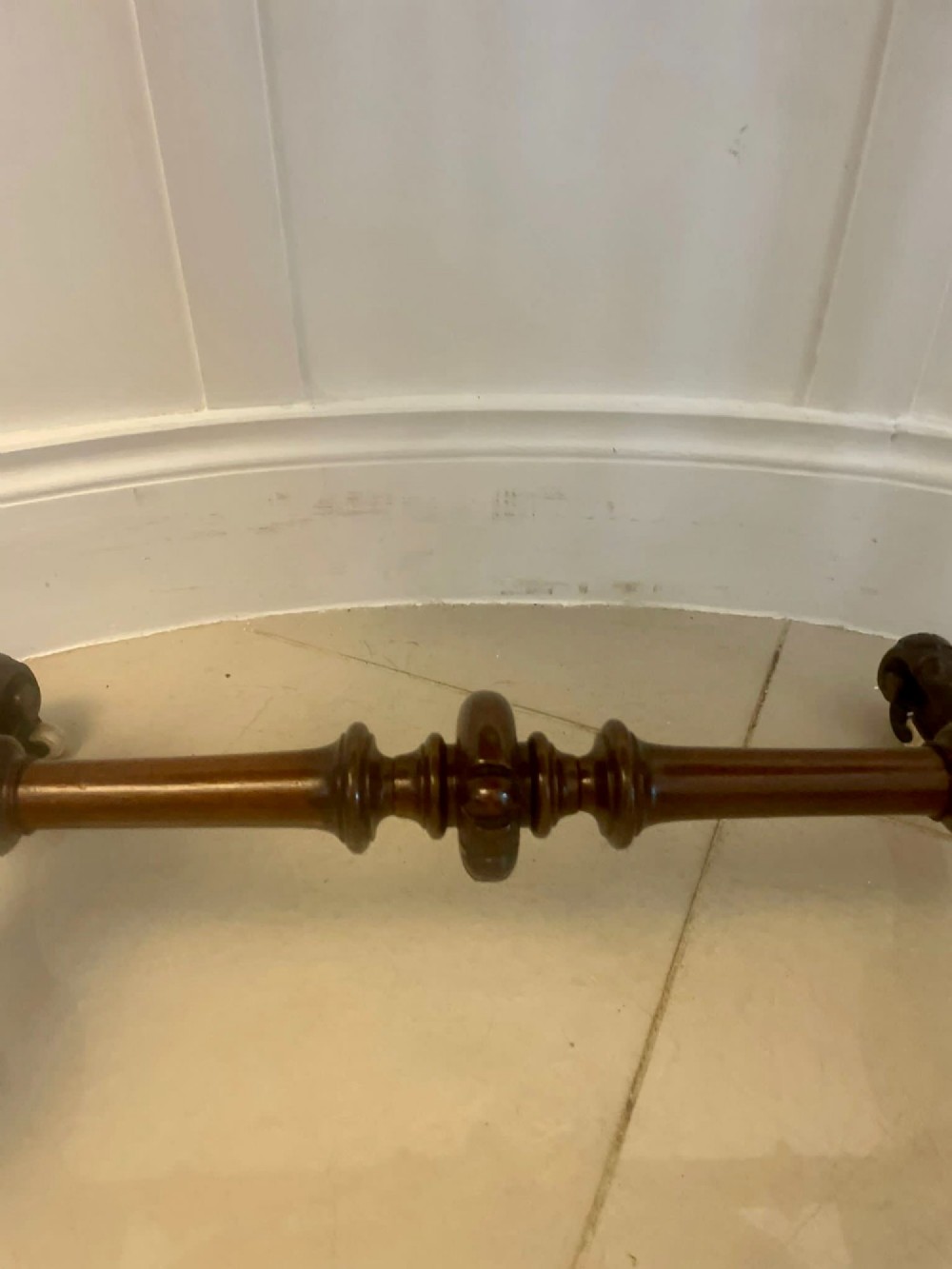 An antique Victorian oval lamp table crafted from burr walnut with turned end supports, a central stretcher, and carved legs with castors. View X