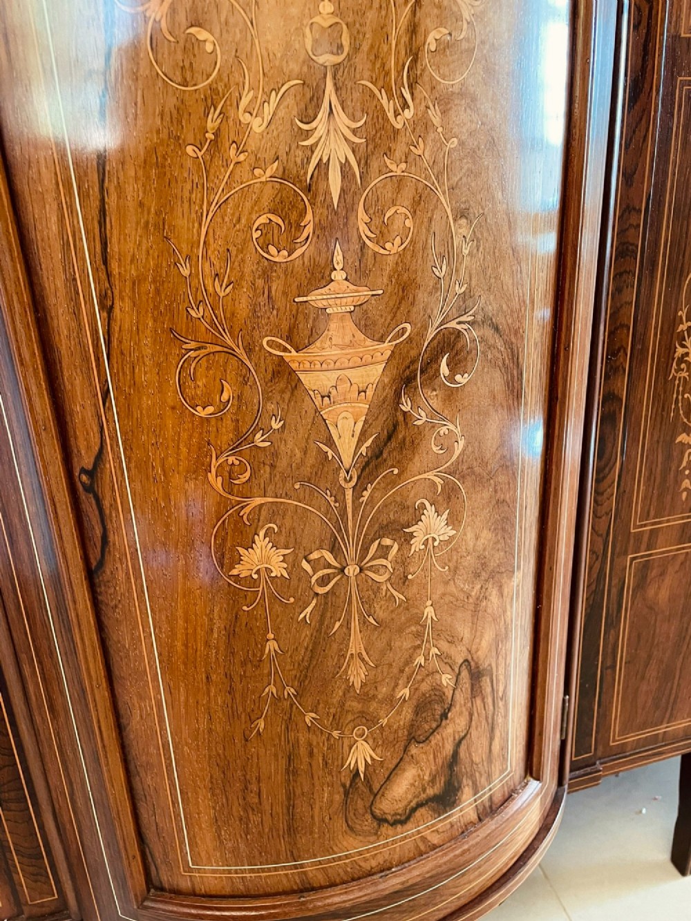 An antique Victorian dark rosewood side cabinet featuring intricate floral inlay, multiple bevelled mirror sections, open shelving, and a central cupboard door. View II