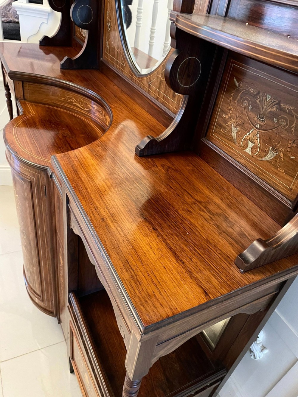 An antique Victorian dark rosewood side cabinet featuring intricate floral inlay, multiple bevelled mirror sections, open shelving, and a central cupboard door. View III