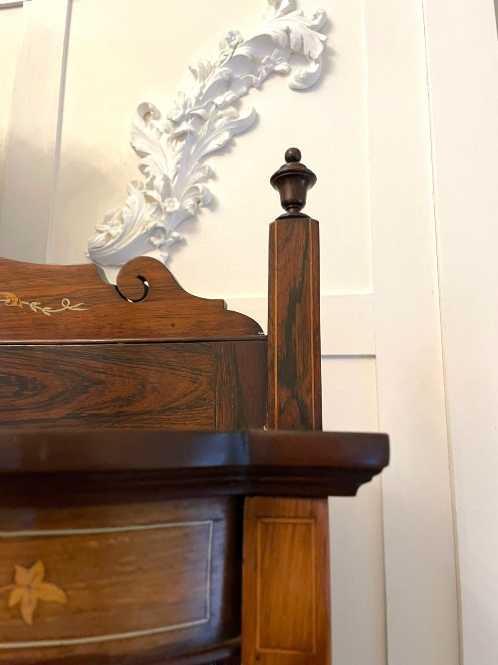 An antique Victorian dark rosewood side cabinet featuring intricate floral inlay, multiple bevelled mirror sections, open shelving, and a central cupboard door. View V