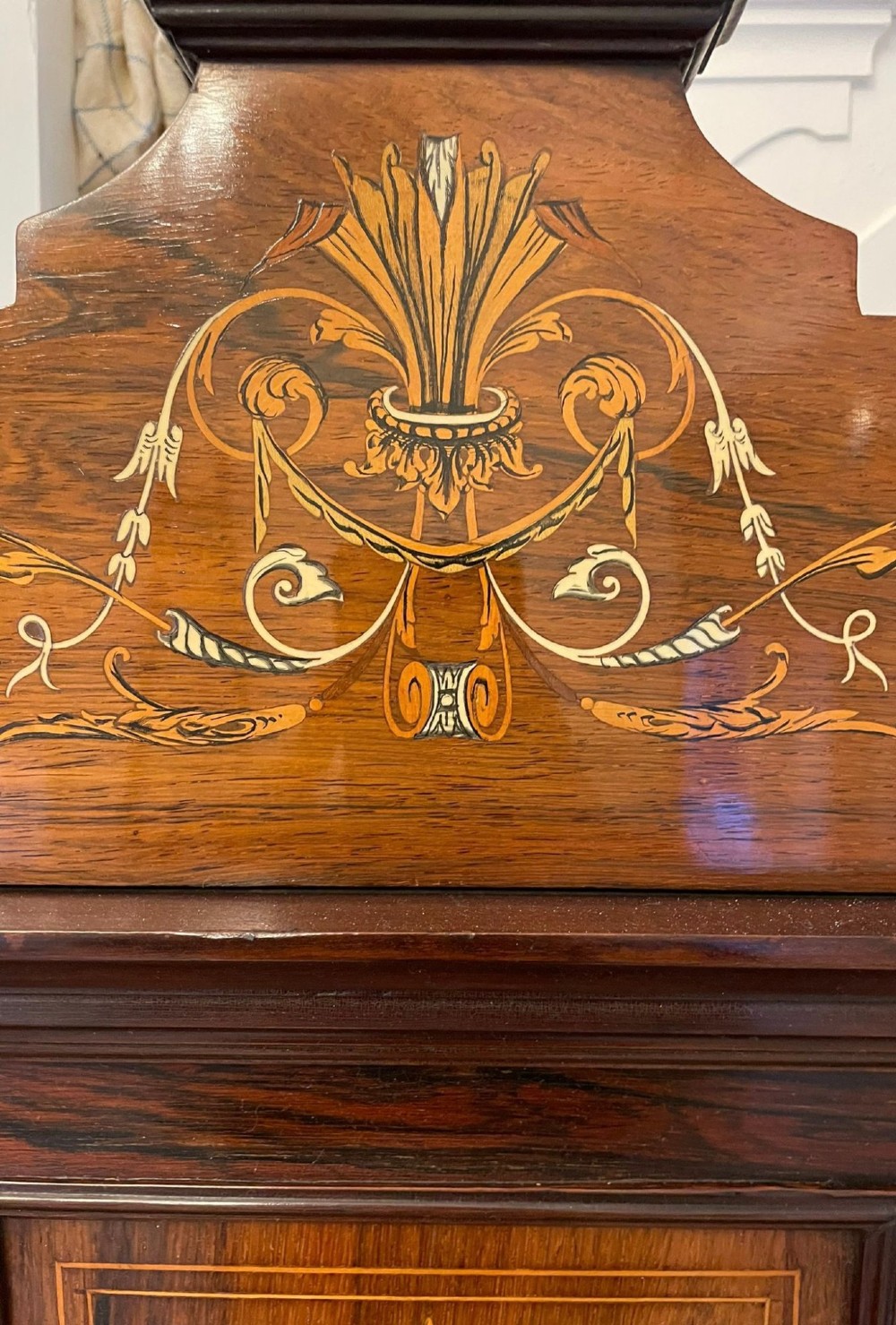 An antique Victorian dark rosewood side cabinet featuring intricate floral inlay, multiple bevelled mirror sections, open shelving, and a central cupboard door. View VI