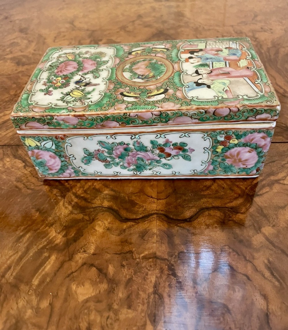 A rectangular 19th-century Chinese Canton Famille Rose porcelain box with lid decorated with hand-painted figure panels, pink flowers, and green scroll motifs. View VIII