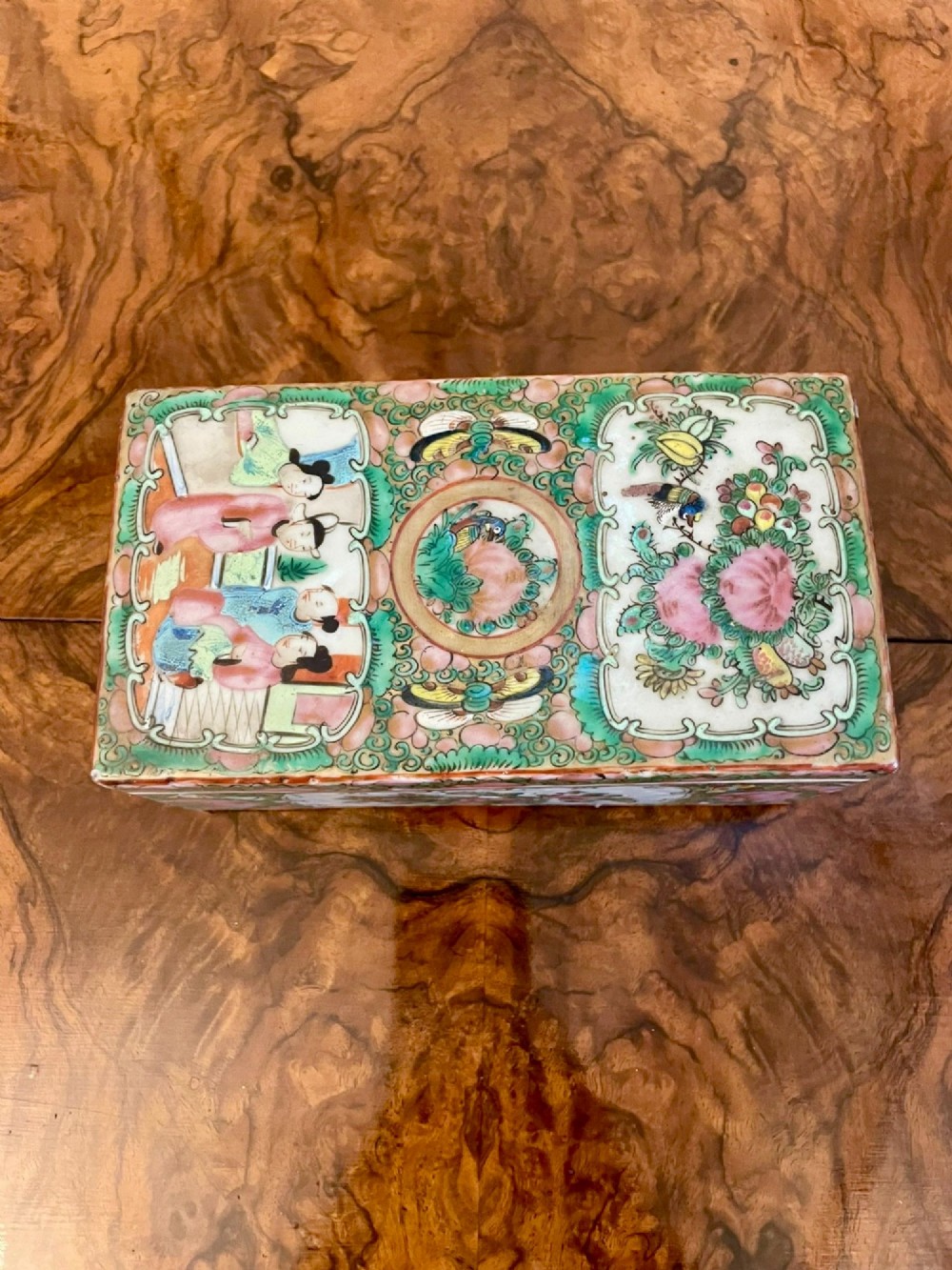 A rectangular 19th-century Chinese Canton Famille Rose porcelain box with lid decorated with hand-painted figure panels, pink flowers, and green scroll motifs. View XI