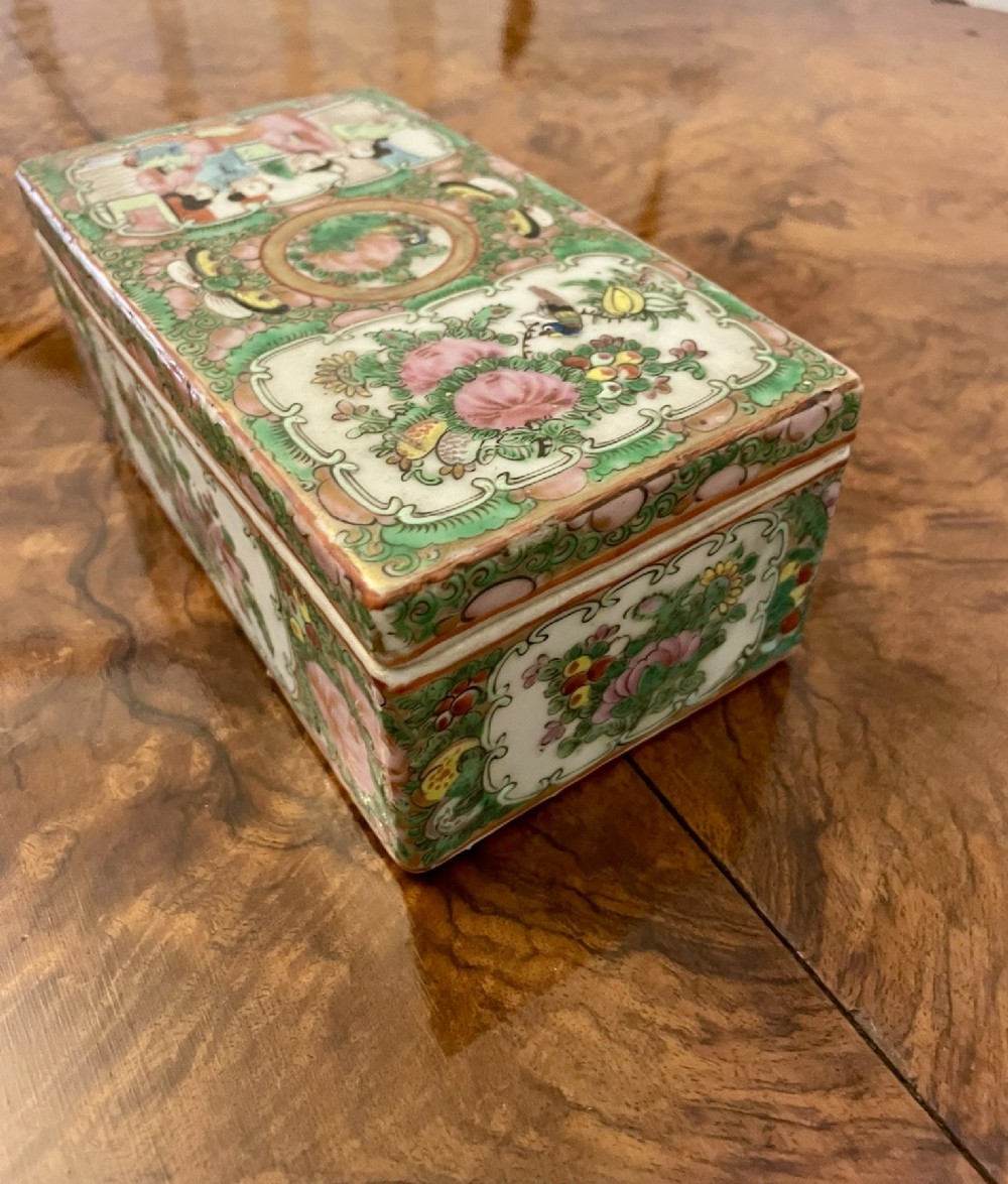 A rectangular 19th-century Chinese Canton Famille Rose porcelain box with lid decorated with hand-painted figure panels, pink flowers, and green scroll motifs. View XII