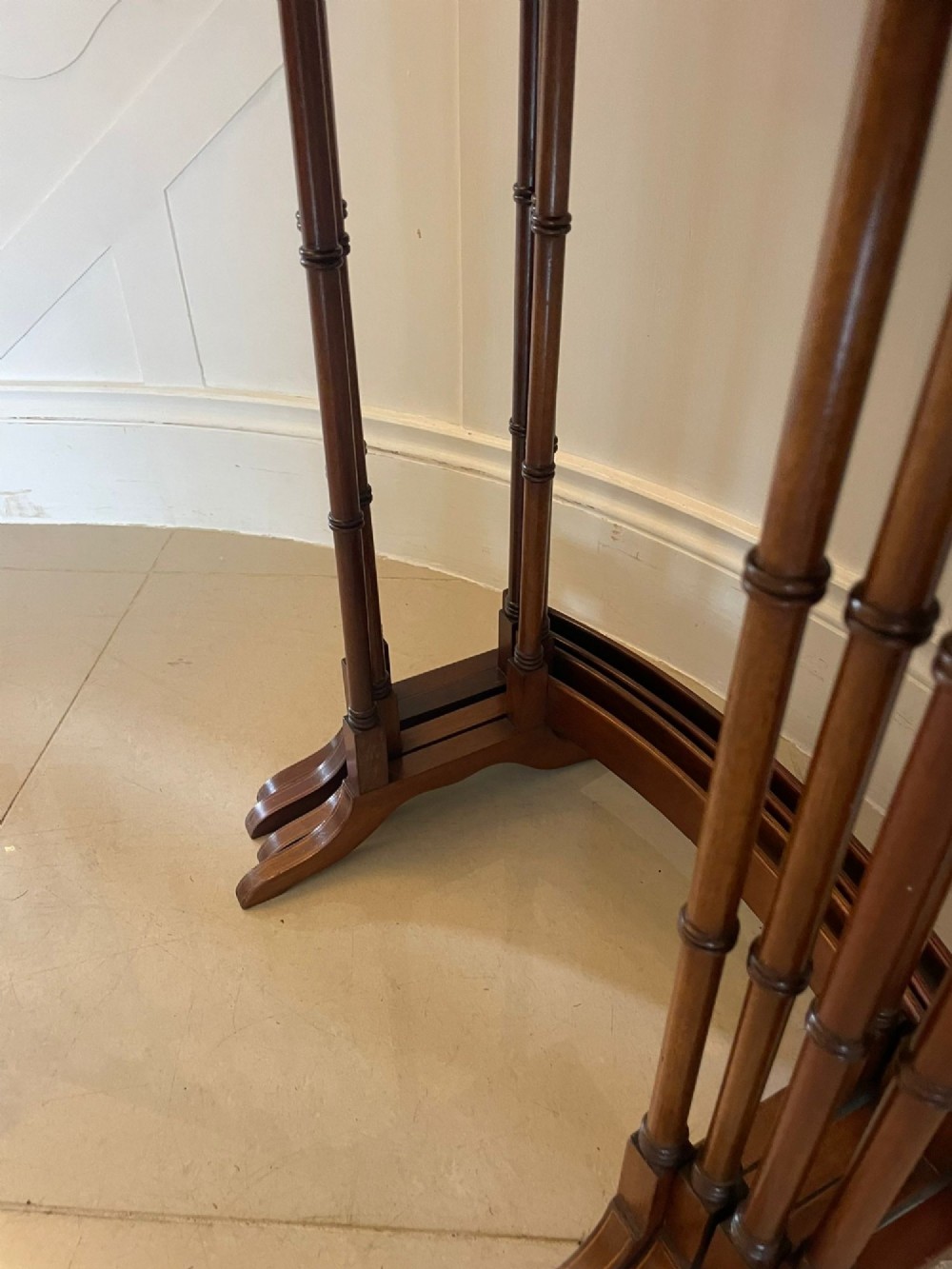 A set of four graduated Edwardian mahogany nesting tables with inlaid tops and slender turned legs arranged in a stepped display. View III