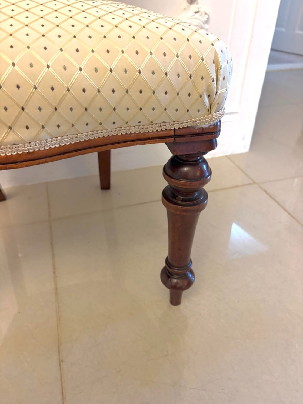 A set of four antique Victorian mahogany dining chairs featuring open balloon-shaped backrests, turned front legs, and cream patterned upholstery. View IV