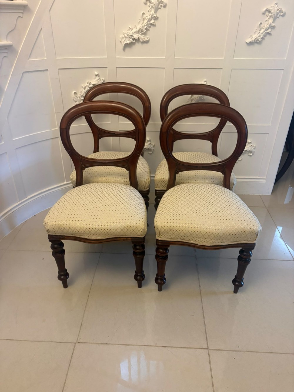 A set of four antique Victorian mahogany dining chairs featuring open balloon-shaped backrests, turned front legs, and cream patterned upholstery. View XIII