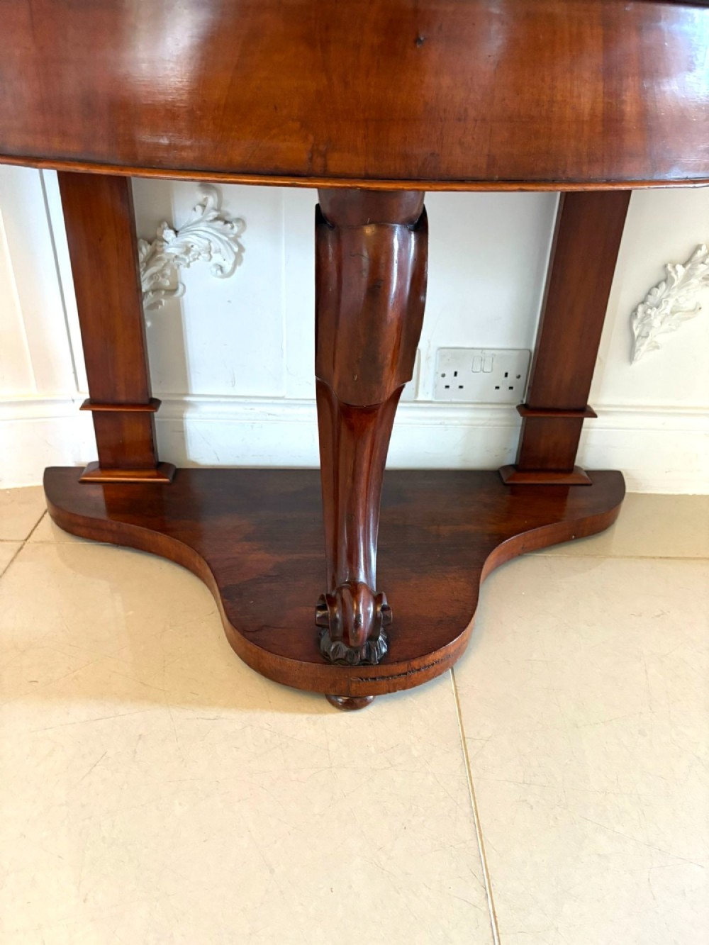 An antique Victorian mahogany dressing table featuring an arched swing mirror with scroll supports above a curved tabletop and shaped platform base. View IX