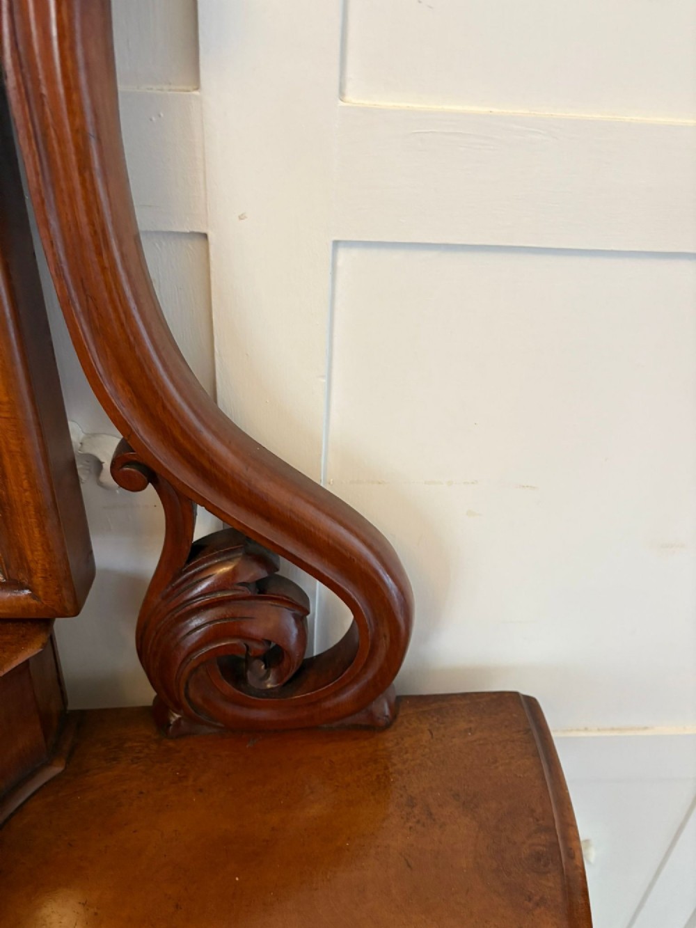 An antique Victorian mahogany dressing table featuring an arched swing mirror with scroll supports above a curved tabletop and shaped platform base. View XI