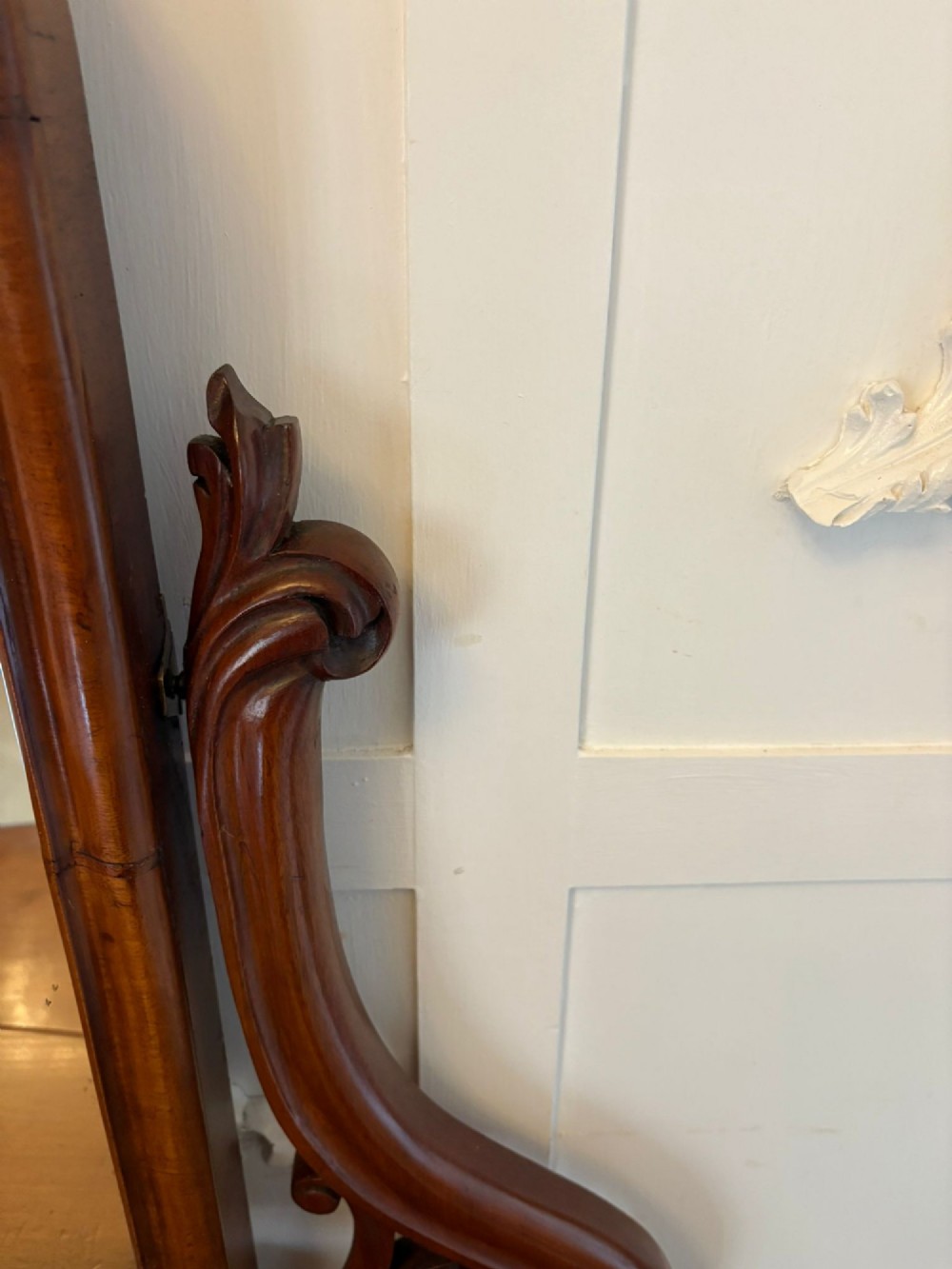 An antique Victorian mahogany dressing table featuring an arched swing mirror with scroll supports above a curved tabletop and shaped platform base. View XII