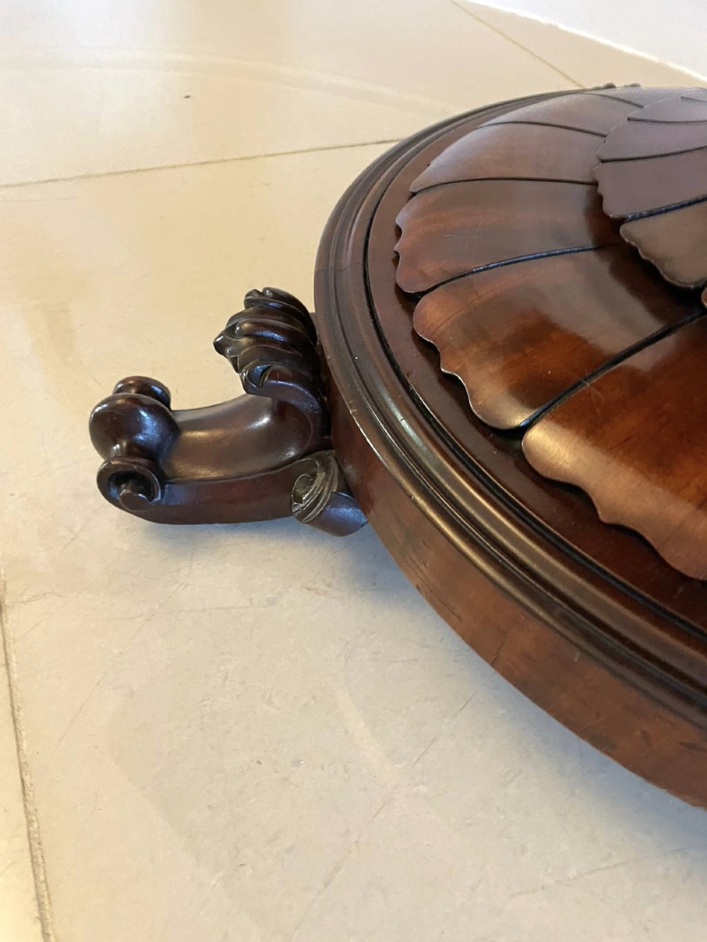 A Victorian mahogany fold-over card table featuring a rectangular top, carved apron, turned central pedestal, and four scroll feet. View X