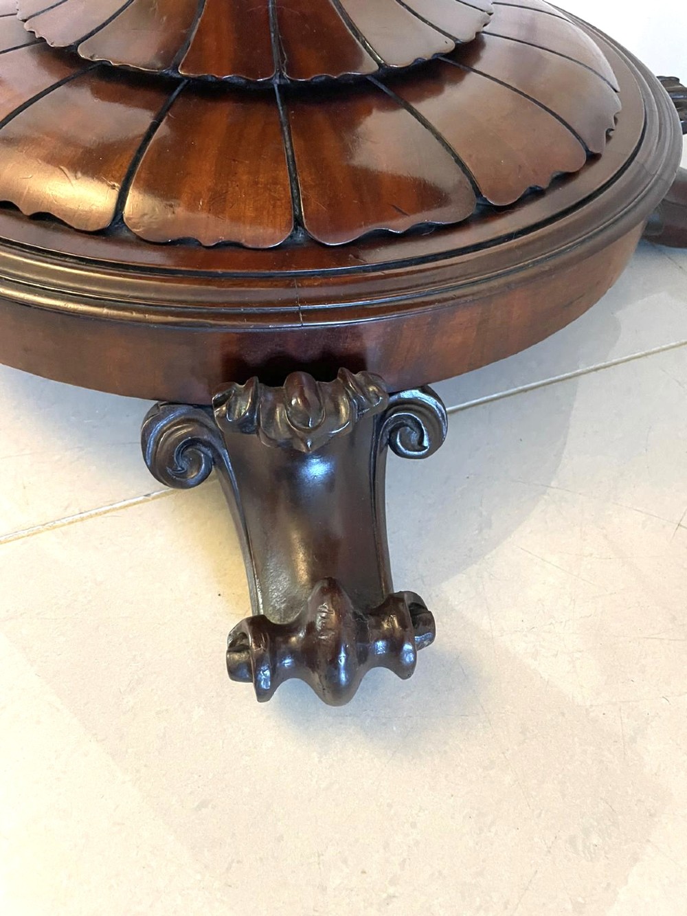 A Victorian mahogany fold-over card table featuring a rectangular top, carved apron, turned central pedestal, and four scroll feet. View XI