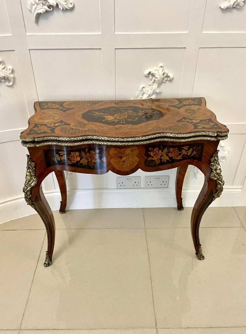 A French Rococo style kingwood card table featuring floral marquetry inlays, gilt-bronze ormolu mounts, and curved cabriole legs. View III