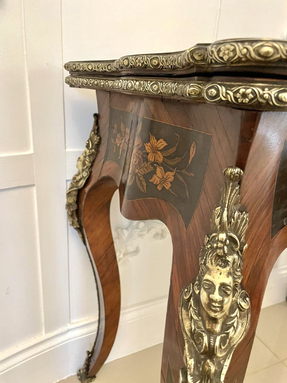 A French Rococo style kingwood card table featuring floral marquetry inlays, gilt-bronze ormolu mounts, and curved cabriole legs. View V