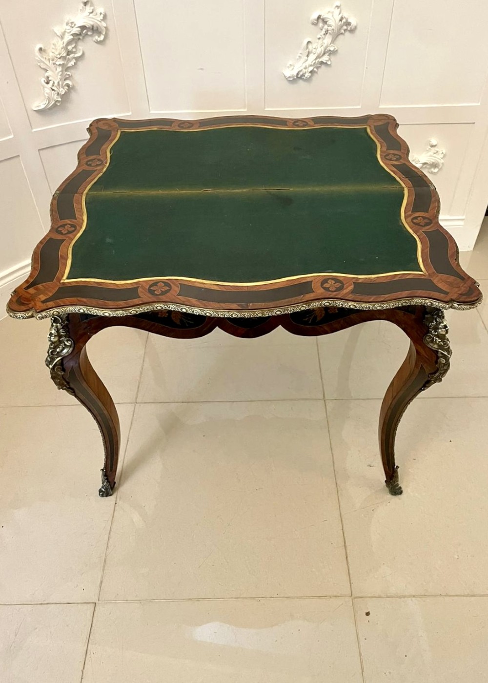 A French Rococo style kingwood card table featuring floral marquetry inlays, gilt-bronze ormolu mounts, and curved cabriole legs. View IX