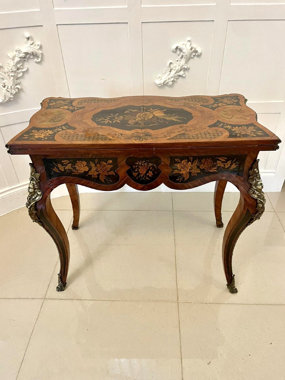 A French Rococo style kingwood card table featuring floral marquetry inlays, gilt-bronze ormolu mounts, and curved cabriole legs. View XI
