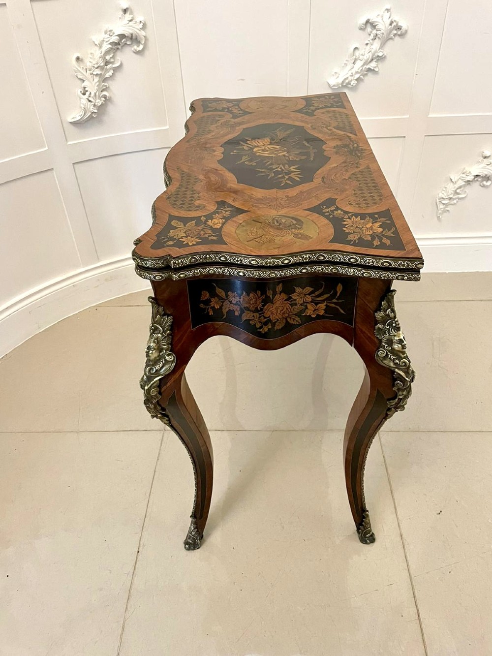 A French Rococo style kingwood card table featuring floral marquetry inlays, gilt-bronze ormolu mounts, and curved cabriole legs. View XII