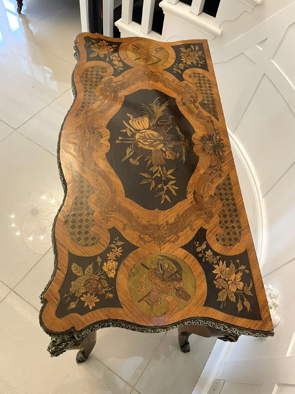 A French Rococo style kingwood card table featuring floral marquetry inlays, gilt-bronze ormolu mounts, and curved cabriole legs. View XIV
