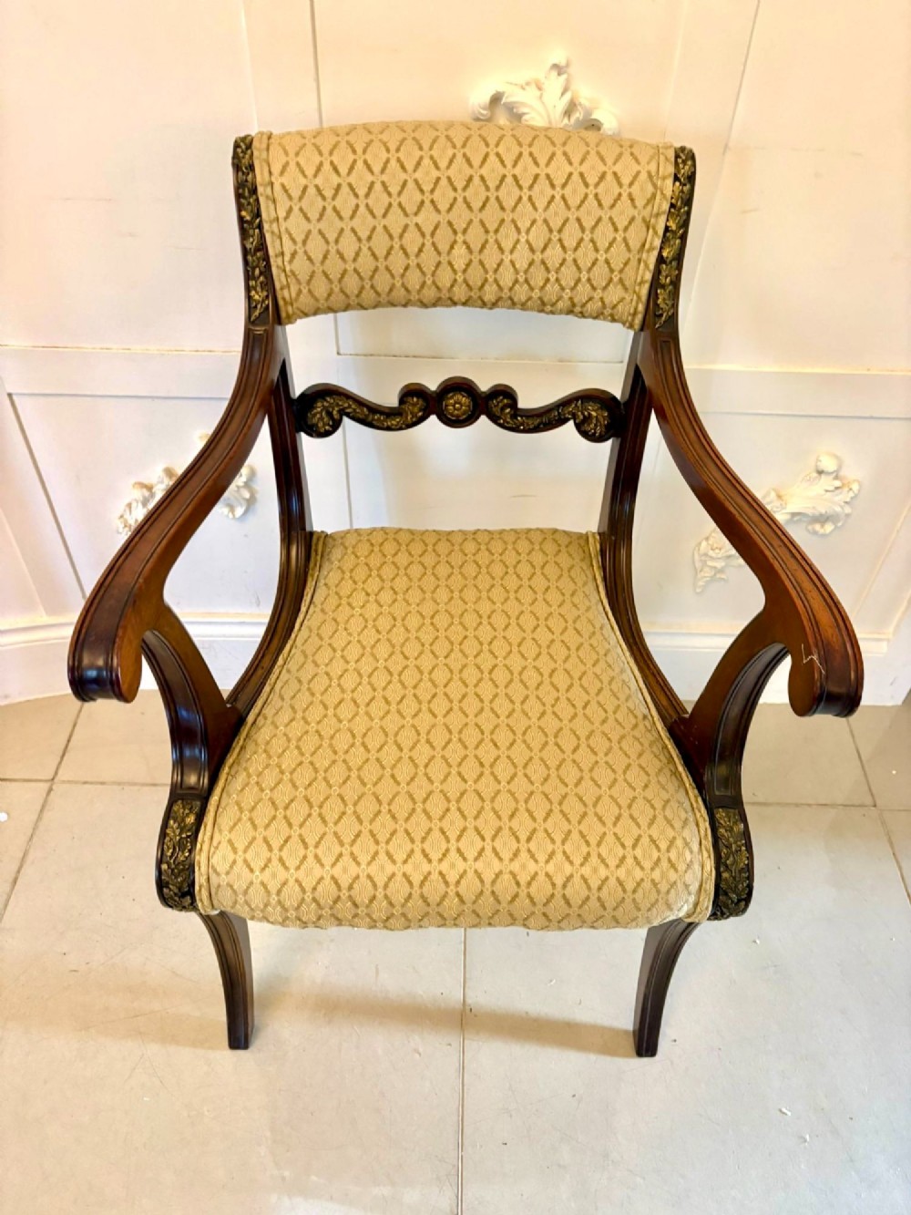 A set of eight antique Regency mahogany dining chairs featuring patterned gold upholstery, carved scrolling mid-rails, and brass detailing. View IX