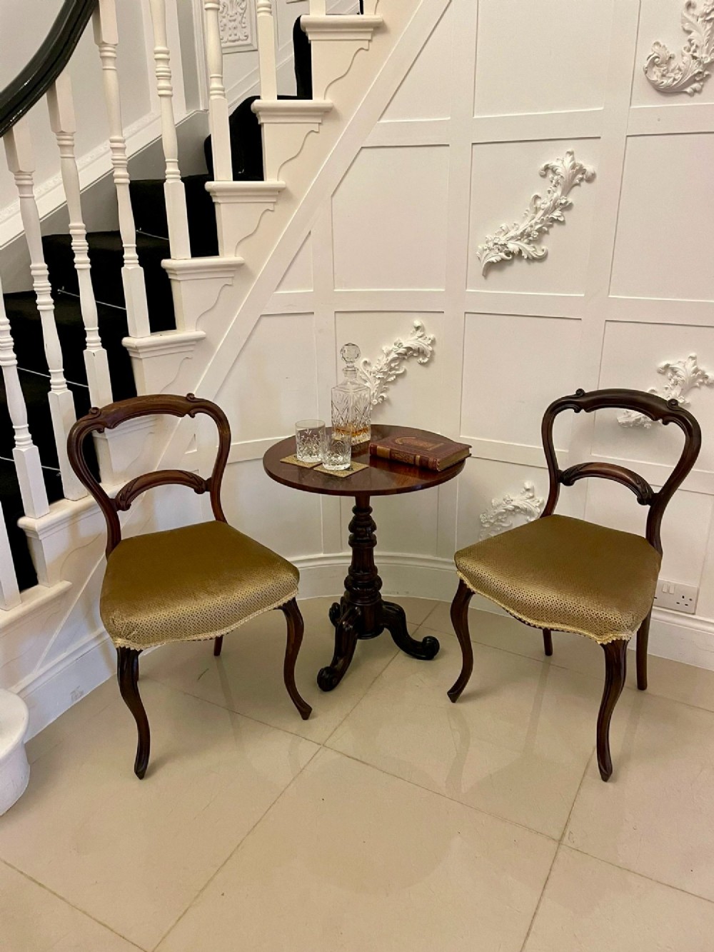 A Victorian rosewood circular lamp table shown in a tilted position, featuring a turned central column and carved tripod legs with scroll feet. View II