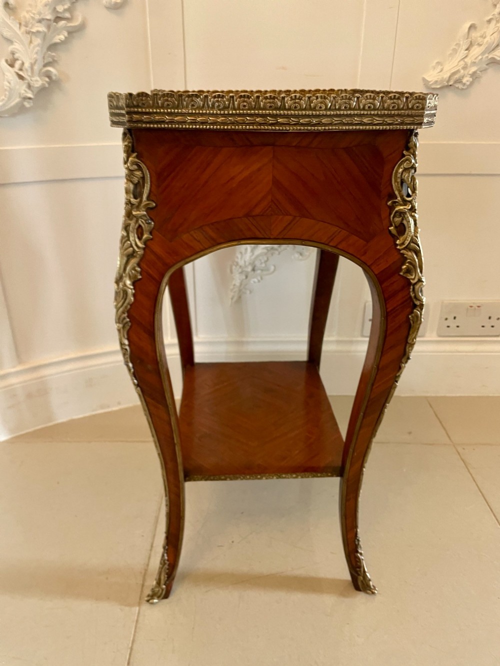 A French-style kingwood lamp table featuring polished parquetry veneer, gilt-bronze mounts, cabriole legs, a lower shelf, and a pierced brass top rim. View VIII